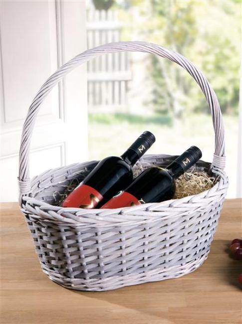 Preview: Geschenkkorb oder Einkaufskorb aus Weide geflochten, grau gekalkt, auf einem hellen Holztisch, gefüllt mit 2 Flaschen Wein.
